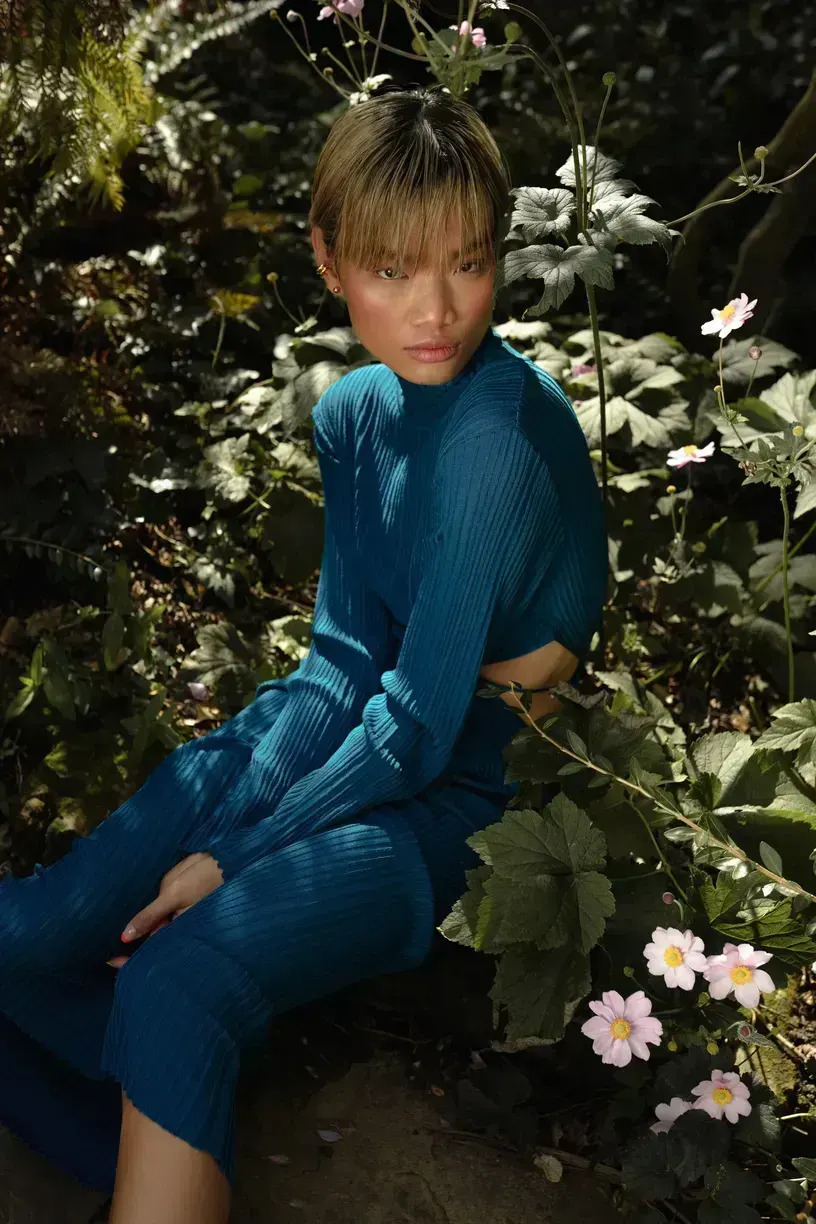 Editorial beauty look photographed among greenery and flowers