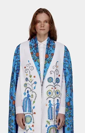 Editorial styling with an embroidered robe and statement makeup